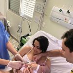 Papai Vanderson cortando o cordão umbilical  do Lucas.